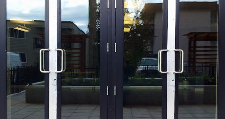 Stainless steel Astragals attached covering the door jamb gaps.